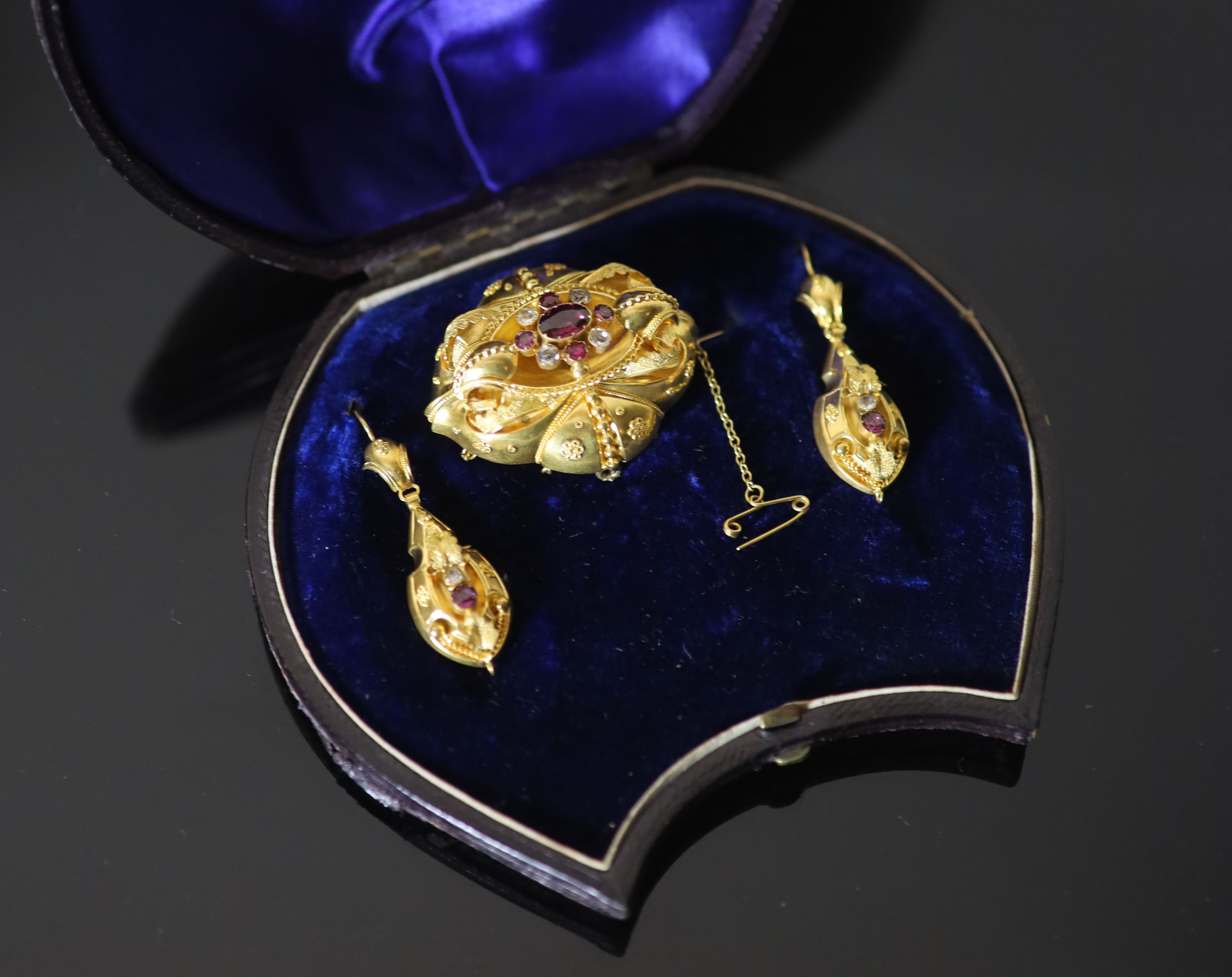 A Victorian 15ct gold, garnet and white stone set demi parure,